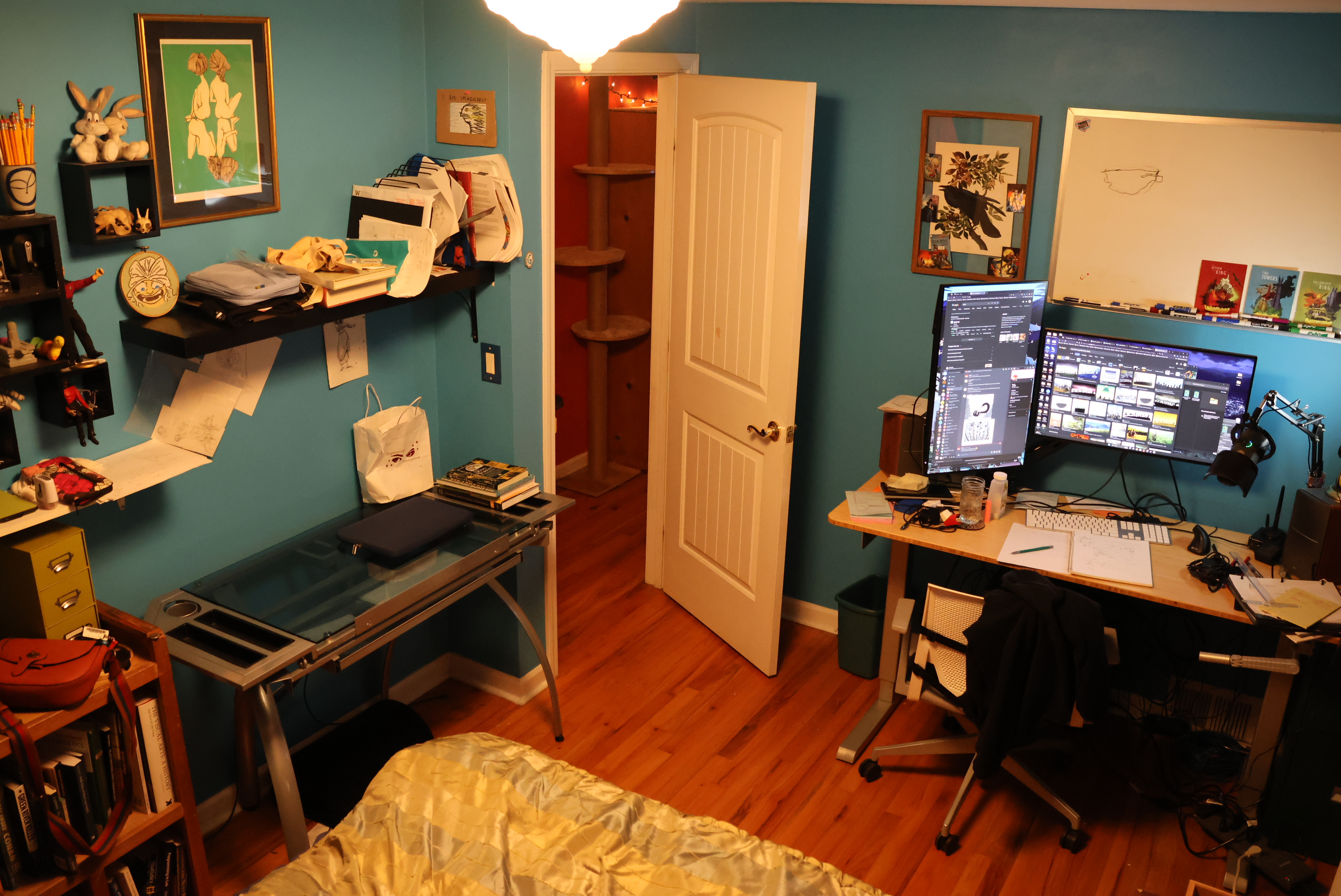 Morrie's office in 2023. Her desk now turned to face the wall, and her mac gone since her new computer is powerful enough to handle all the various tasks she needs for it. There are a few more art pieces on the wall, and you can't reeeeally tell in the photo, but we've replaced the trundle bed with a king.